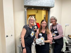 Three women volunteers in the kitchen