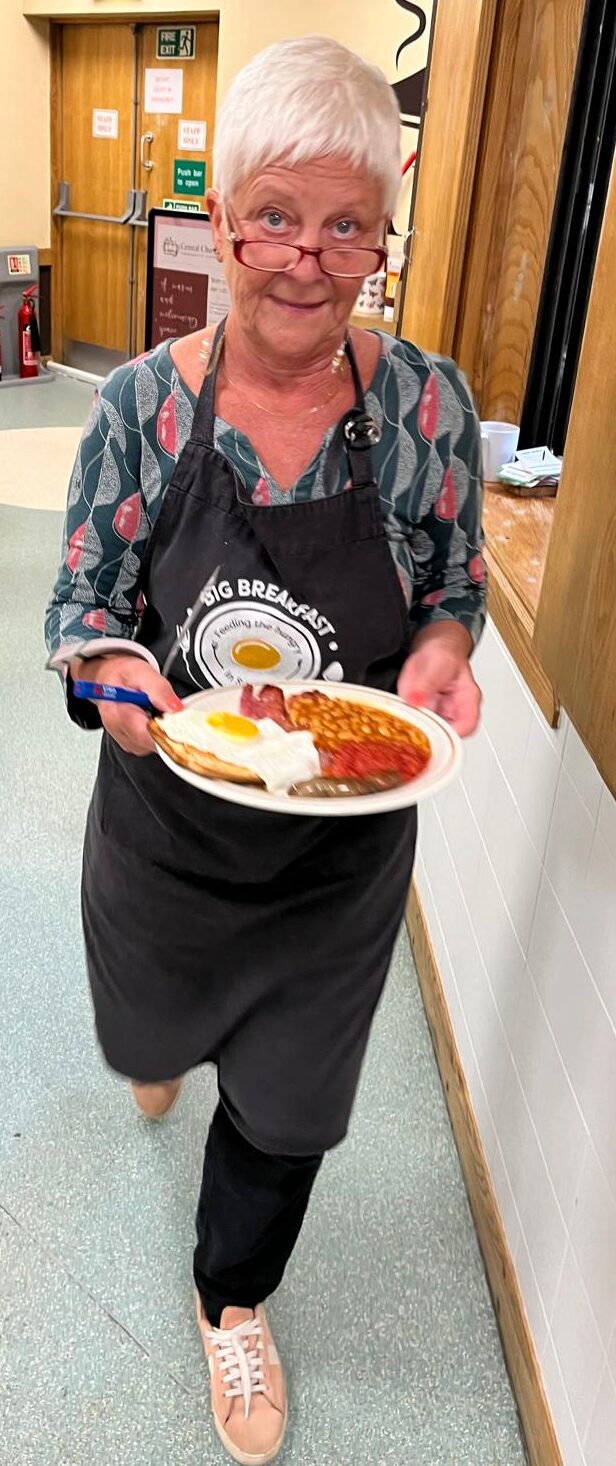 Angela serving a full breakfast plate